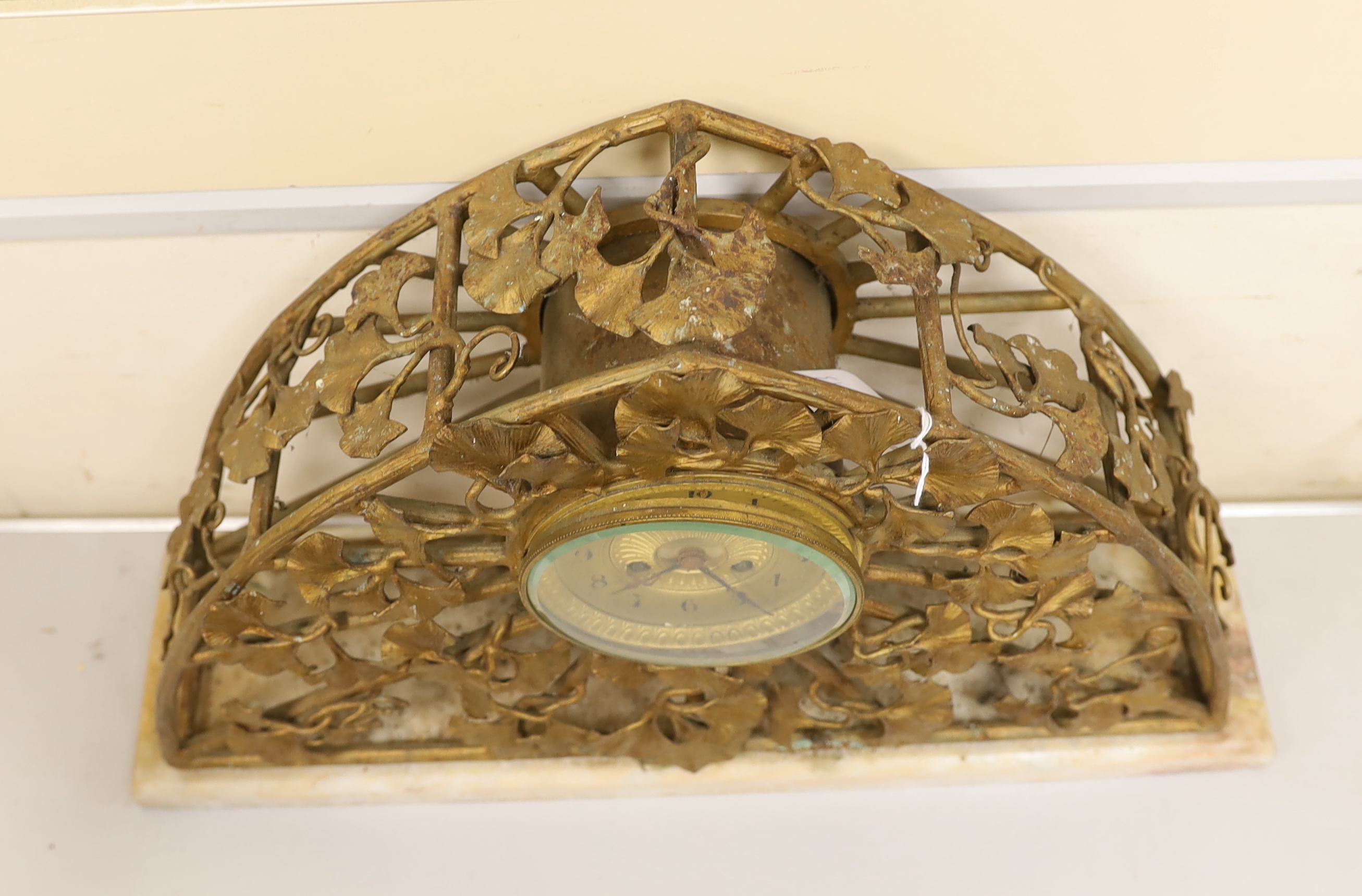 An Art Nouveau gilt metal mantel clock, 51cm wide, 33cm high